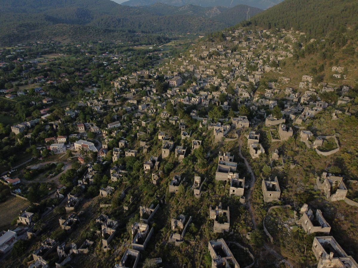 Roofless abandoned stone houses on the hillside at Kayaköy